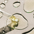 Load image into Gallery viewer, Close-up of a dropper with liquid on a textured surface